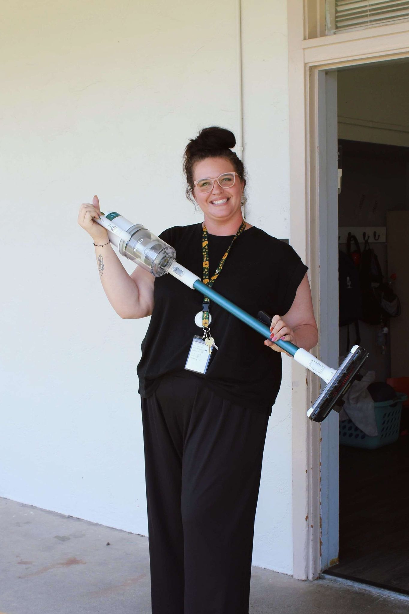 Teacher holding up a swiffer.